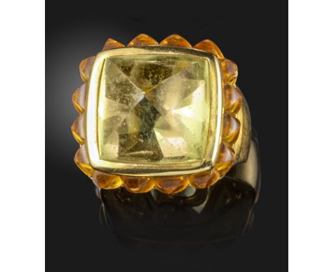 An unusual citrine and yellow gold ring, the sugarloaf light green centre citrine is set within a surround of citrine sugarlo