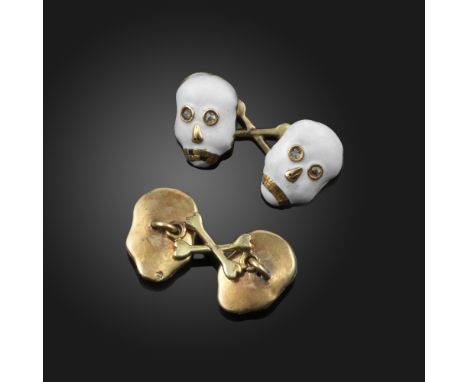 A pair of gold and enamel Calavera style skull cufflinks, each skull decorated with white enamel, set with rose-cut diamond e