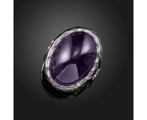 An amethyst cabochon ring by Geoffrey Rowlandson, set in striated rubover white gold mount, maker's mark and London hallmarks