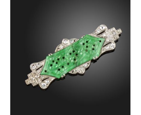 A diamond and jade brooch, the carved jade panel (damaged) depicting flowers, is set within diamond-set surround in white gol