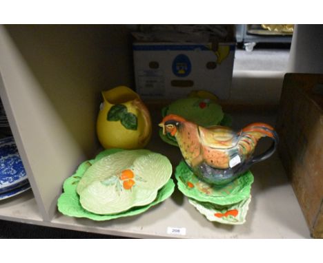 A collection of early 20th century Carlton Ware cabbage pattern plates and a Rooster tea pot.