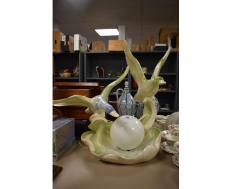 A large mid century Italian made ceramic table centre piece lamp of two mallard ducks in flight over waves with globe style e