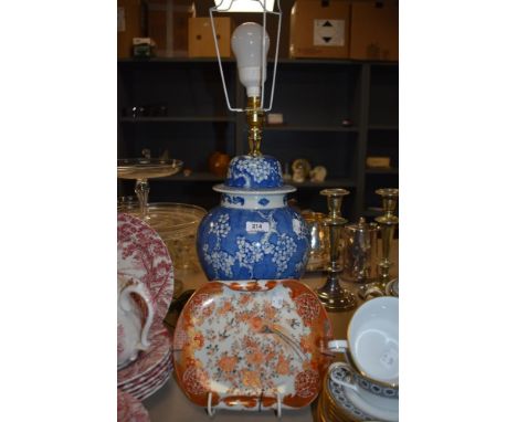 A modern Chinese styled lamp base with an antique Japanese Kutani ware folded rim dish having historic repairs.