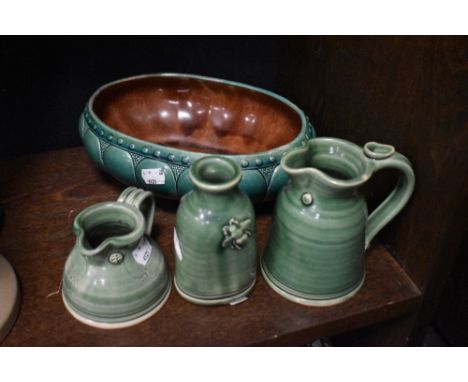 Three pieces of modern studio pottery in green glazes with a similar ceramic bowl
