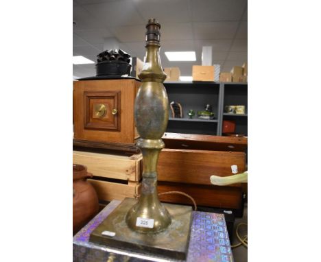 An antiqued Arts and Crafts styled lamp base in brass on a large square base. 50cm tall aprox.