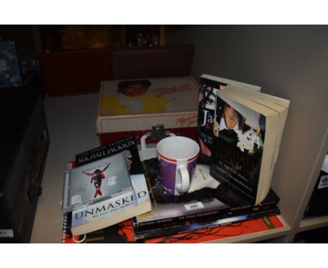 A selection of Michael Jackson collectables including a record player, biographies and calendar
