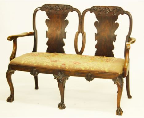 A FINE CHIPPENDALE STYLE WALNUT DOUBLE CHAIR BACK SETTEE. Shaped scroll splatapplied with scrolling foliage. Drop in tapestry