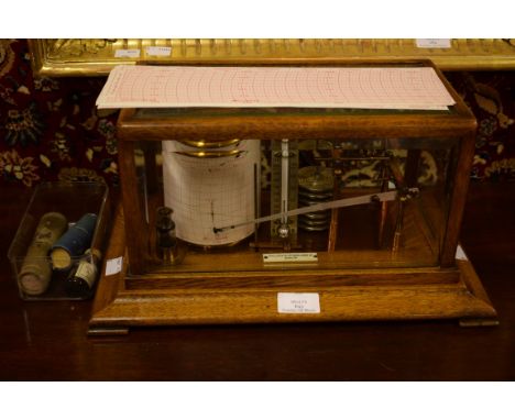 A GOOD QUALITY OAK CASED BAROGRAPH. With the trade label of Pollock and Company,Dublin, Ireland. Five glass panels, and a lif