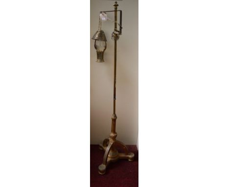 A TELESCOPIC BRASS LAMP STANDARD. With brass step, and basket shaped lamp holder, ontriform giltwood base. (1)
