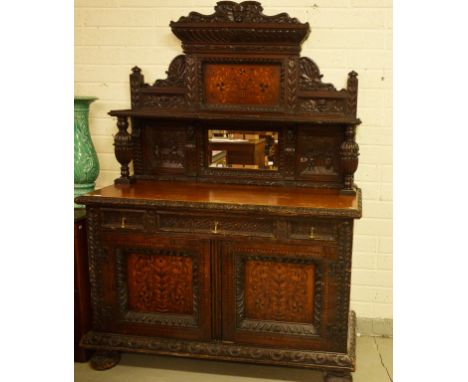 A SEVENTEENTH CENTURY STYLE OAK AND INLAID MARQUETRY BUFFET. The topcrested with a classical mask above a floral inlaid panel