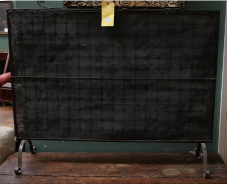 A LARGE WROUGHT IRON CHEVAL FIRE SCREEN, with mesh panel, raised on four scrolllegs. 41" (104cm) wide. (1)