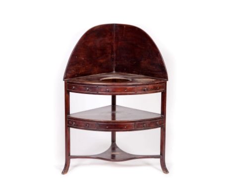 AN IRISH GEORGE IV PERIOD MAHOGANY BOW-FRONTED CORNER WASH STAND, byWilliams and Gibton. Stamped and number 10543. Three-quar