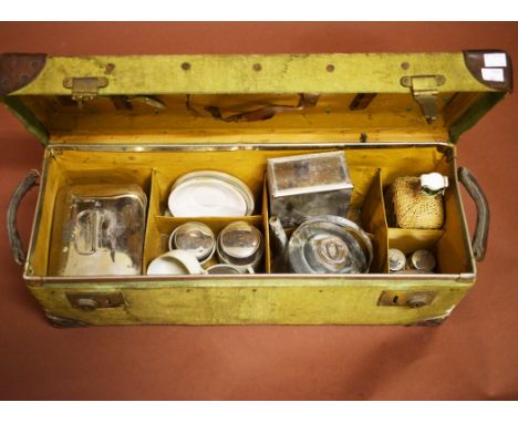 AN OLD CANVAS COVERED AUTOMOBILE PICNIC SET. With studded leather corners andfitted interior with various implements. Incompl