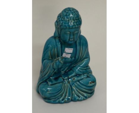 A TURQUOISE GROUND CRACKLEWARE CERAMIC FIGURE OF A SEATED BUDDHA holdingright arm up. 13" (33cm) high. (1)