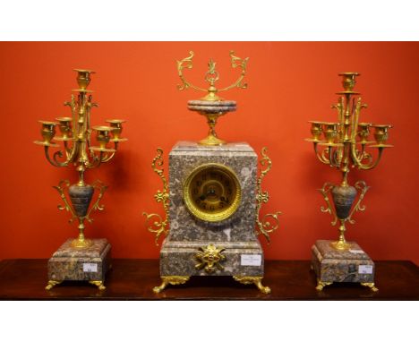 A THREE PIECE FRENCH MARBLE MANTLE PIECE CLOCK GARNITURE. Comprisingspeckled grey marble case clock, the movement with an out