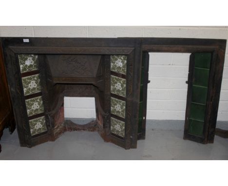 TWO SIMILAR CAST IRON MANTELPIECE INSETS. One with a relief moulded upper hood,flanked with four coloured tiles to either sid