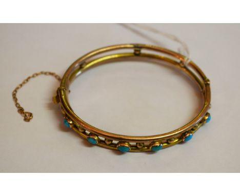 A NINE CARAT GOLD BANGLE. Early twentieth century. Set with six oval turquoise stones.2.5" (6.5cm) high. 8g. (1)