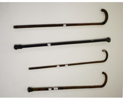 A SILVER MOUNTED AND EBONISED WALKING STICK. Together with a silver mountedbamboo stick and two other bamboo sticks. (4)