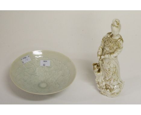 AN UNUSUAL LIGHT CELADON GROUND CHINESE PORCELAIN BOWL. With etcheddecoration depicting infants amongst foliage. 6.75" (17cm)