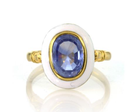 An antique unheated Ceylon sapphire and enamel dress ring in high carat yellow gold set with a central blue sapphire of appro