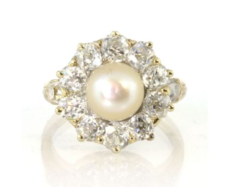 An antique French natural pearl and diamond cluster dress ring in 18ct yellow gold set with a central natural pearl of 7.6mm 