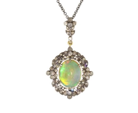 An antique opal and diamond pendant and chain in gold set with a central oval cabochon opal of approximately 4cts, within a f