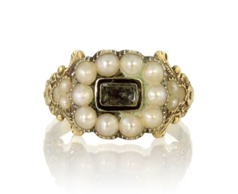 An antique Georgian hairwork and pearl mourning ring in 18ct yellow gold set with a central rectangular crystal panel surroun