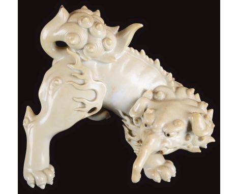 A Blanc De Chine Figure of Baku:19th century, in a crouched position about to leap, H 17cm x W 20cm.  Note: Baku was a Chines