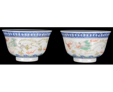 Two Chinese famille rose cups:19th century, decorated with dragons chasing flaming pearls. Guangxu (1875-1908) mark to the ba