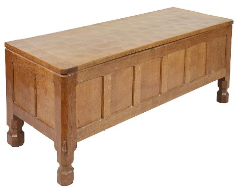 A Robert Thompson "Mouseman" Blanket Chest:Oak, the hinged rectangular lid above a six panel front, raised on faceted block f