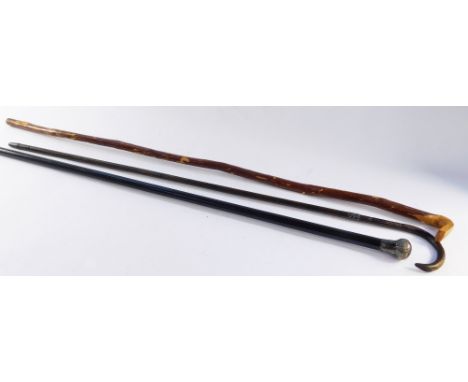 Three walking sticks, comprising a Victorian ebony walking stick with silver knop, London 1901, a bamboo cane with silver col