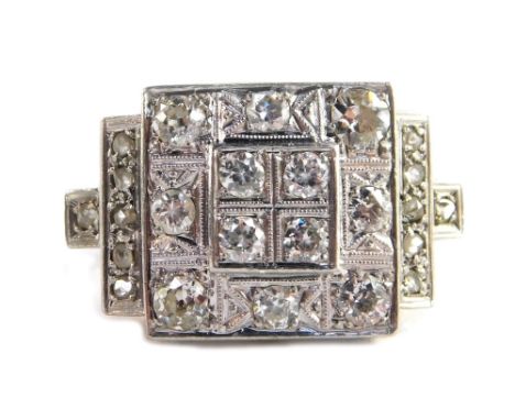 An Art Deco diamond ring, with square cluster set ring head, with outer halo panel and diamond set shoulders, each rose cut, 