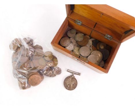 A wooden storage box and contents of coins and medals, to include half pennies, three pences, various two shillings and a 191