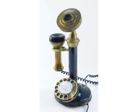 An Astral Telecom candlestick telephone, with speaker and detachable receiver, on black finish with brass ends and dial, 38cm