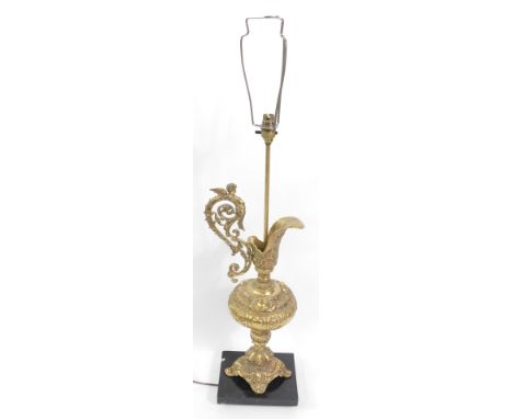A Continental brass table lamp, of baluster form, with scrolling cherub handle, and rococo scroll decoration, on a rectangula