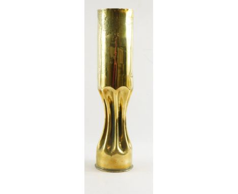 A WWI trench art cartridge, with hammered tulip and wreath scroll detailing, within a fluted rim, with shell case base stampe