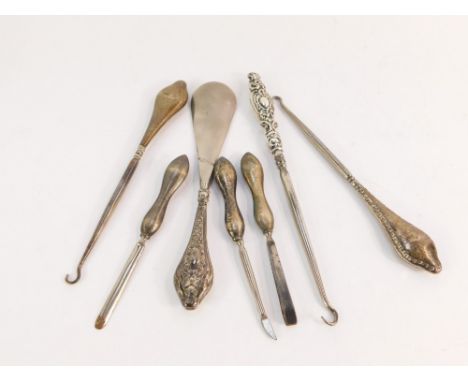 A group of silver handled manicure tools, comprising shoe horns, button hooks and manicure implements, 6½oz gross.  (a quanti