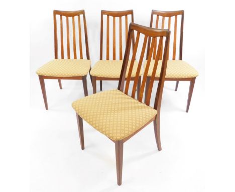 A set of four G-Plan teak 1960's single dining chairs, designed by Leslie Dandy, upholstered in floral gold patterned upholst