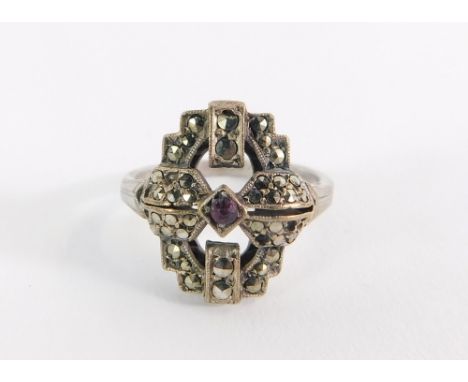 A silver and marcasite set dress ring, the art deco style ring set with marcasite with central garnet stone, ring size O, mar