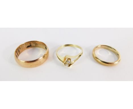 Three bands, comprising a 9ct gold wedding band of plain design, 2.8g, a two stone diamond dress ring, yellow metal, stamped 