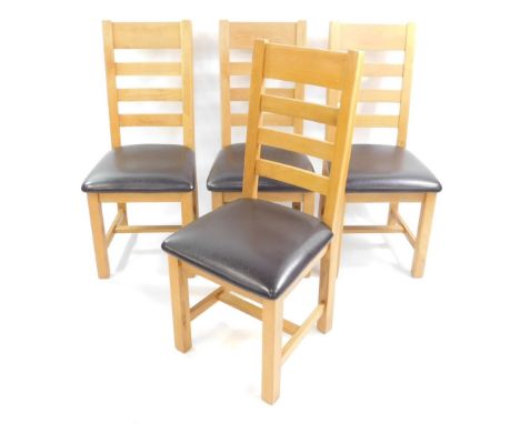 A set of four light oak ladder back single dining chairs, with over stuffed leather seats.