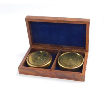 Nautical Interest. A pair of calendar and compass dials, in a fitted wooden case, with brass anchor inlay, 4cm high, 14cm wid