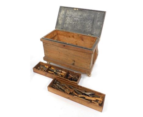 A pine tool chest, containing an assortment of chisels, planes and other woodworking tools, chest 56.5cm high, 87cm wide, 44c