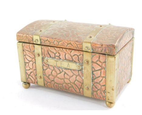 An early 20thC copper and brass tea caddy, of domed rectangular form with textured finish, and brass strap work, with brass '