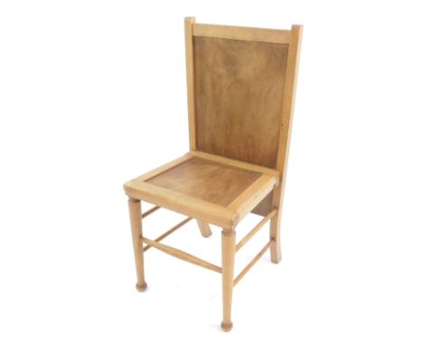 An Arts &amp; Crafts style light beech chair or trouser press, with solid seat and back, raised on turned legs, united by spi