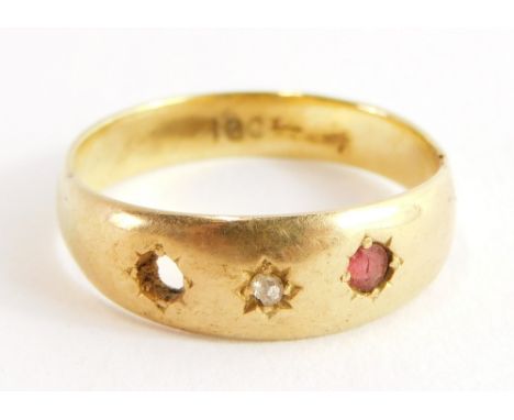 An 18ct gold three stone set dress ring, the setting for two garnets (one missing) and central illusion set tiny diamond, rin