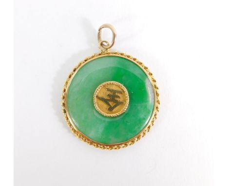 A Chinese Jade pendant, the circular disc with gold rope twist outer border, and central two character medallion, with single