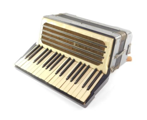 A Hohner Carmen II accordion, in blue, twenty four button.