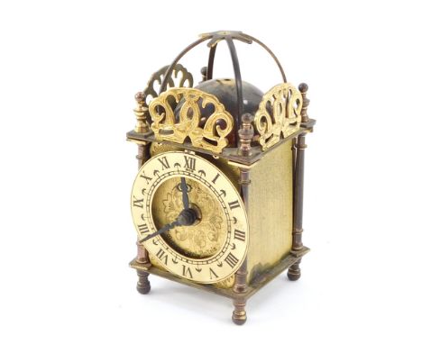 A Smiths Industries brass lantern clock, engraved dial with chapter ring bearing Roman numerals, quartz movement, the case of