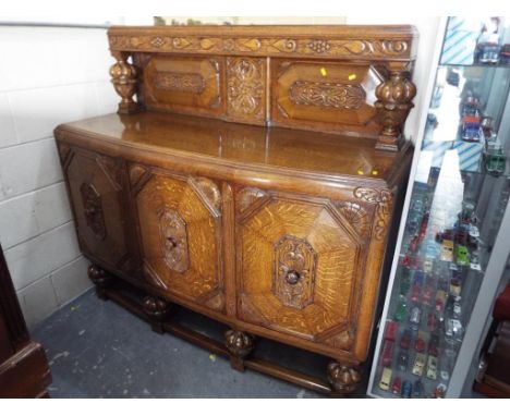 A good quality heavy oak carved front and back section sideboard approx size 145cm (h) x 150cm (w) x 53cm (d) (see matching i